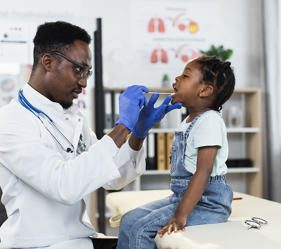 little girl getting throat checked by doctor